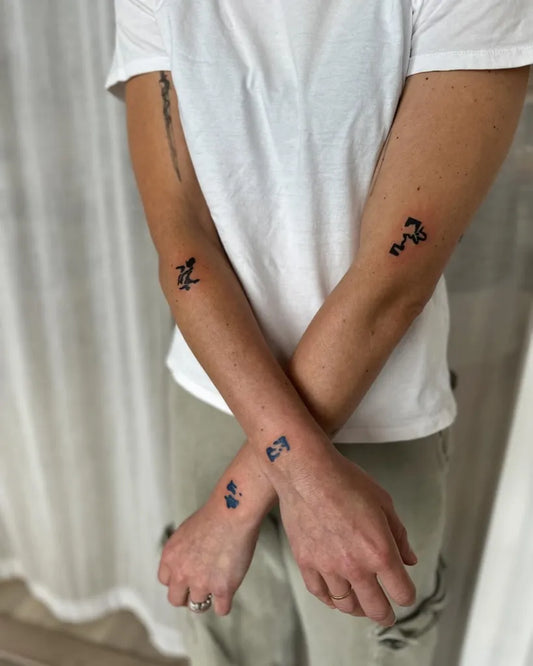 Small Negative Space Abstract Symbols Tattoo on Men Arms by @stinky.tatts