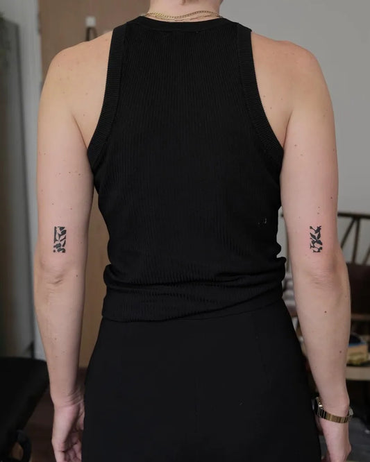 Small Negative Space Abstract Symbols Tattoo on Women Upper Arms by @surreal.lines