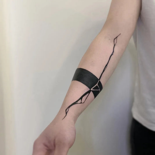Small Negative Space Band with Branches Tattoo on Women Forearm by @sanne_vaghi