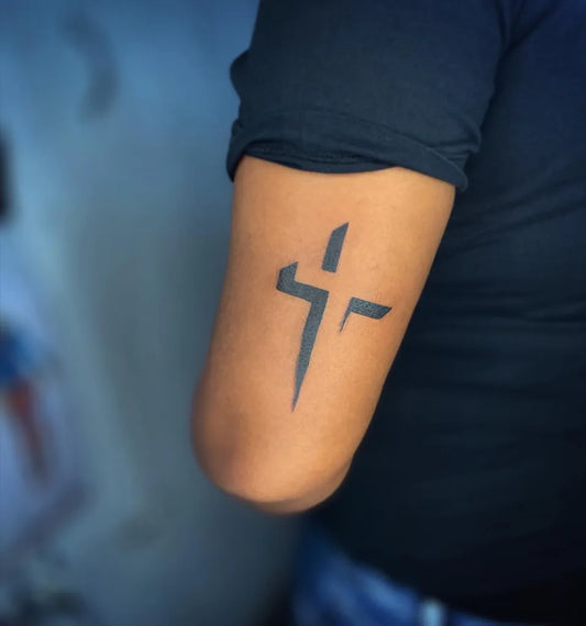 Small Negative Space Cross Tattoo on Women Arm by @miss_lucypop