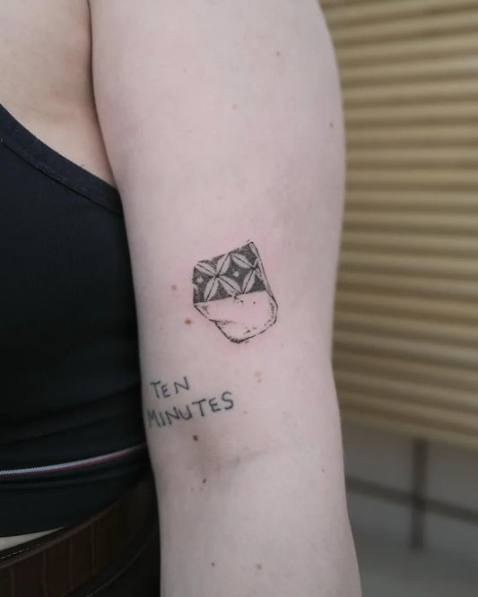 Small Negative Space Cup with Flower Tattoo on Women Arm by @surreal.lines