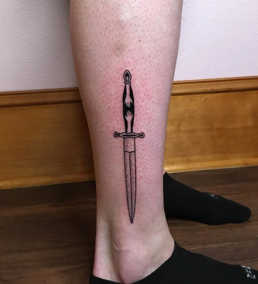 Small Negative Space Dagger Tattoo on Men Leg by @_mariahwoodman_