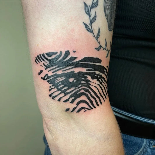 Small Negative Space Fingerprint Tattoo on Women Arm by @_discoteeth