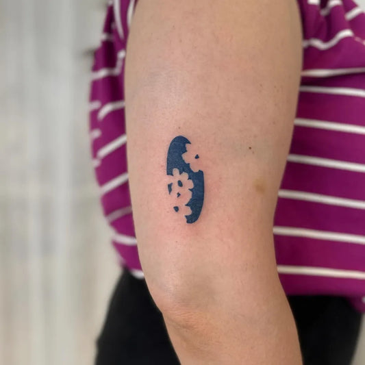 Small Negative Space Flowers Tattoo on Women Arm by @stinky.tatts