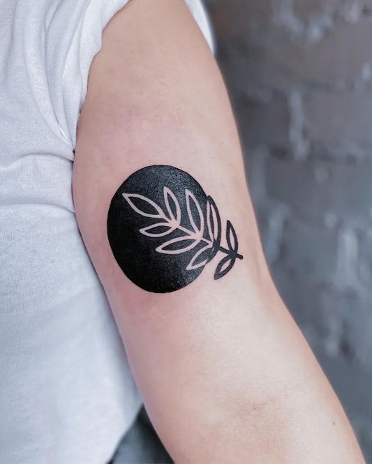 Small Negative Space Leaf Tattoo on Women Arm by @milky.pdf