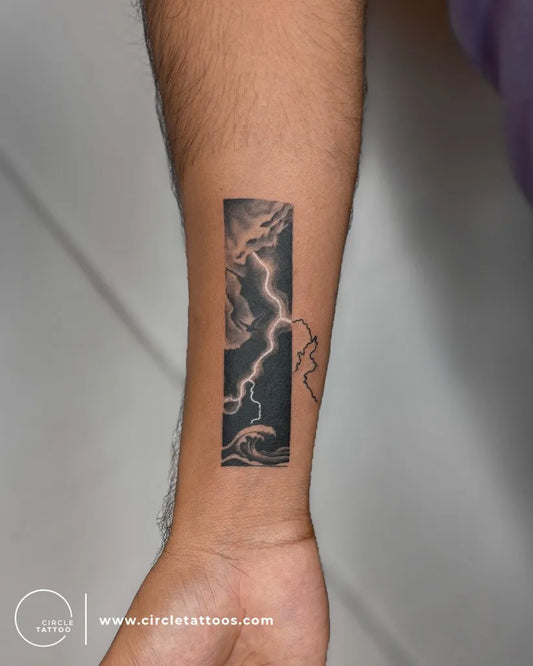 Small Negative Space Lightning Clouds Tattoo on Men Wrist by @circletattoonavimumbai