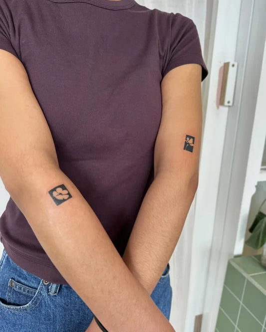 Small Negative Space Paw Print Tattoo on Women Arm by @stinky.tatts