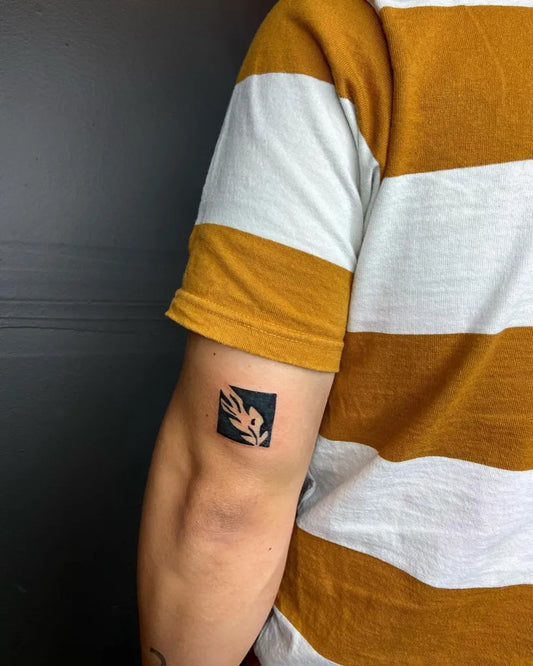 Small Negative Space Square Bird Tattoo on Men Upper Arm by @austin_translation_tattoo