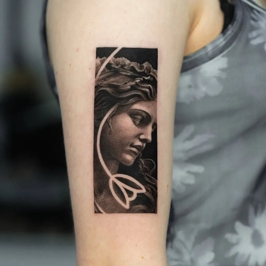Small Negative Space Woman Profile with Curls and Lotus Tattoo on Women Arm by @justinkd_tatts