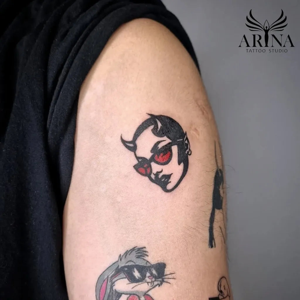 Small Neo Traditional Demon Bunny Tattoo on Men Upper Arm by @arina_tattoostudio