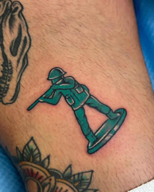 Small Neo Traditional Green Army Soldier Toy Figure Military Tattoo on Men Leg by @squidd.wardo