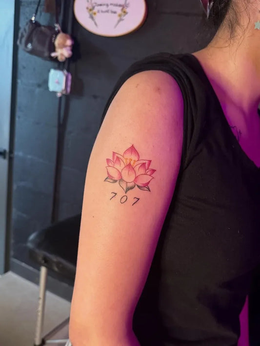 Small Neo Traditional Lotus Flower with Numbers on Women Shoulder Tattoo by @ashlynbrynne