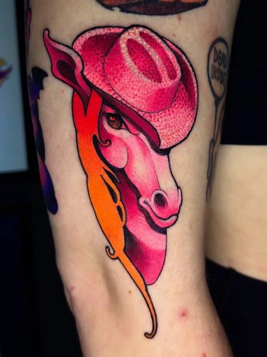 Small Neo Traditional Pink Cowboy Hat Giraffe on Women Arm Tattoo by @thebbgoat
