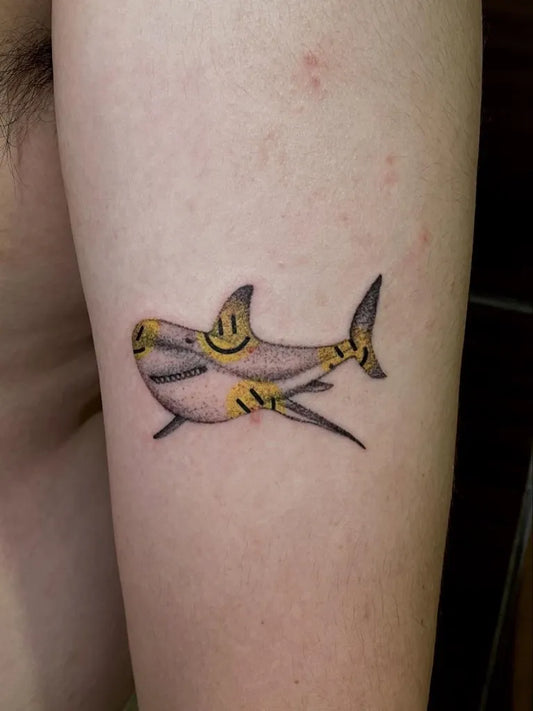 Small Neo Traditional Shark with Smiley Faces on Men Arm Tattoo by @speechless.tattoo