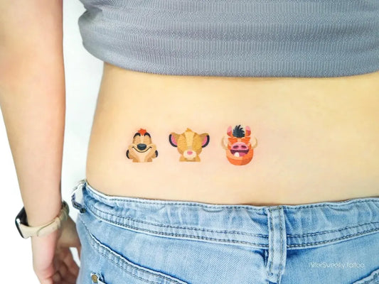 Small Neo Traditional Simba Pumbaa Timon Tattoo on Women Lower Back by @bittersweetly.tattoo
