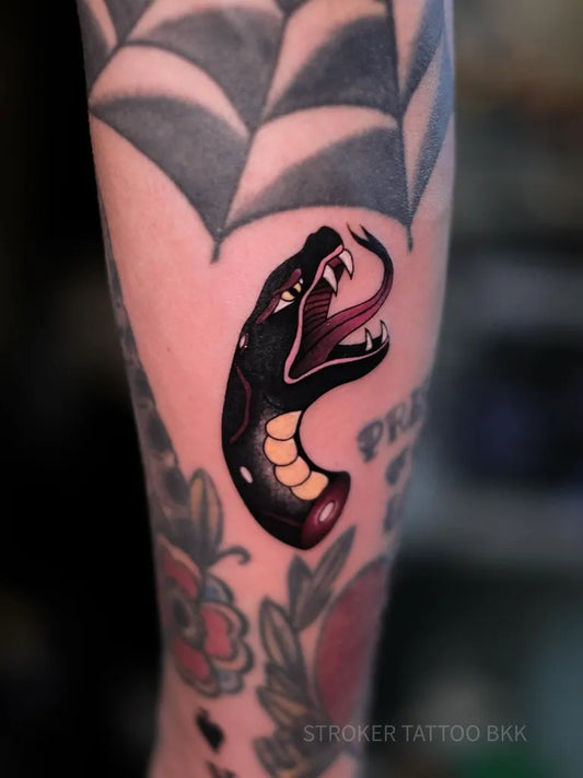 Small Neo Traditional Snake Web on Women Arm Tattoo by @strokertattoo_bangkok