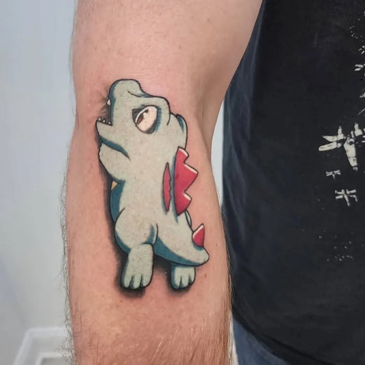 Small Neo Traditional Totodile Pokemon Tattoo on Men Arm by @sidequest_collective