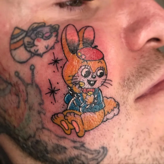 Small Neotraditional Cartoon Bunny on Men Face Tattoo by @abehammytats