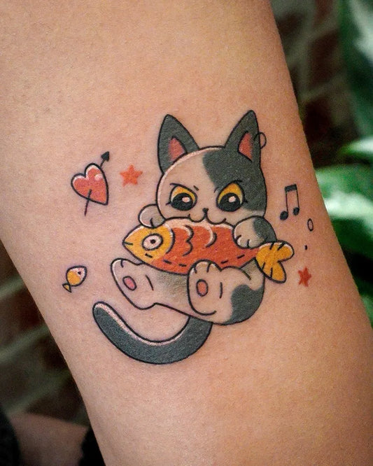 Small Neotraditional Cat with Fish Tattoo on Women Arm by @eden_tattoo_