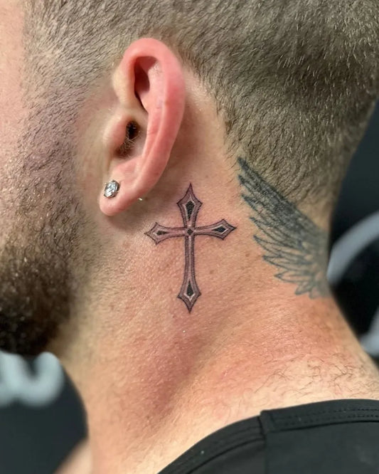 Small Neotraditional Cross with Wings on Men Neck Tattoo by @mr.inkwells