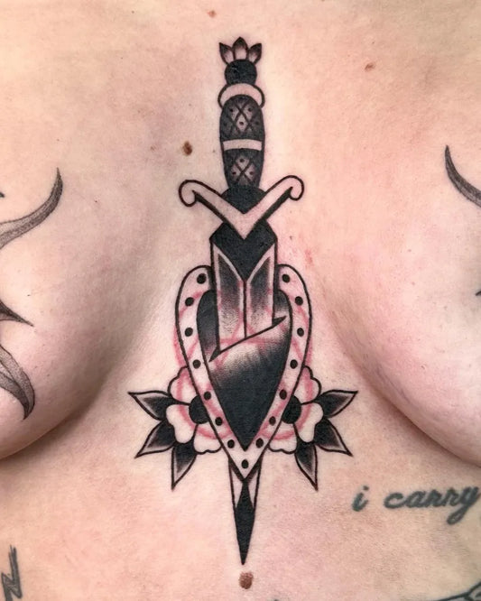 Small Neotraditional Dagger Heart Flowers on Women Sternum Tattoo by @heiditattoo
