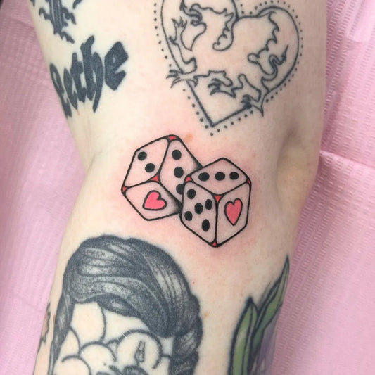 Small Neotraditional Dice Hearts Tattoo on Women Arm by @clarasugarcubestattoo