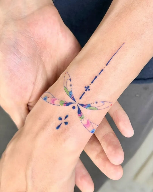 Small Neotraditional Dragonfly on Women Wrist Tattoo by @danzhu.tattoo