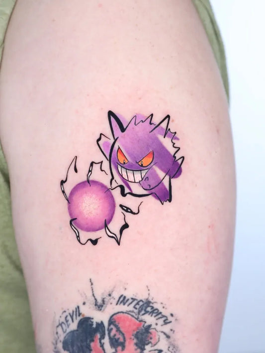 Small Neotraditional Gengar and Purple Orb Tattoo on Women Arm by @gil_miguel_tattoo_