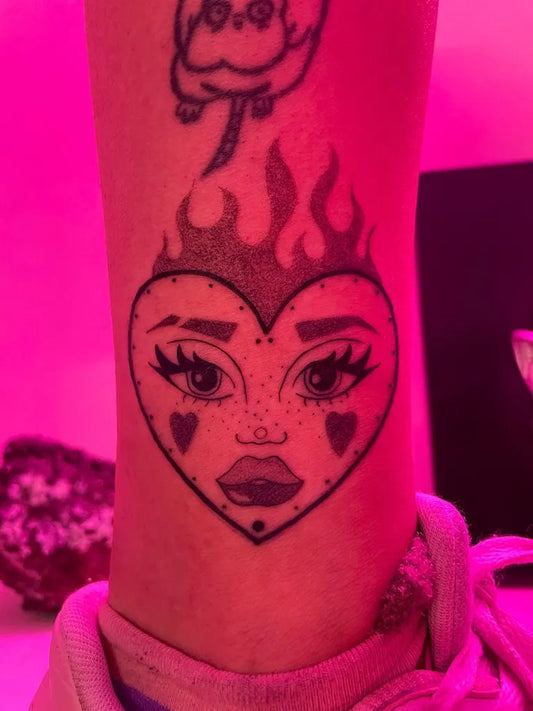 Small Neotraditional Heart Face Cat Flames on Women Leg Tattoo by @_zerendipia_