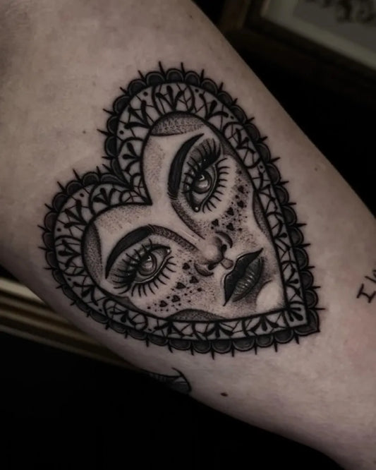 Small Neotraditional Heart Face on Women Arm Tattoo by @kasey.tattoos