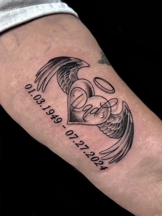 Small Neotraditional Heart Wings Dates on Men Arm Tattoo by @katscratchtattooss