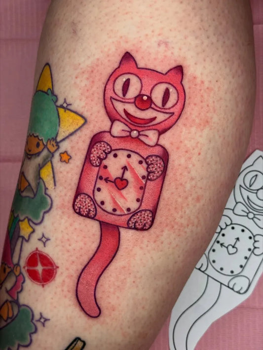Small Neotraditional Kit Cat Clock Tattoo on Women Arm by @bubblegrungetattoos