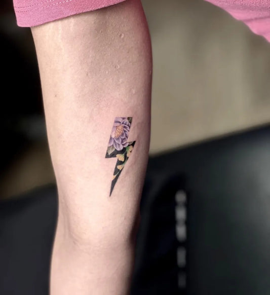 Small Neotraditional Lightning Bolt with Flower Tattoo on Women Arm by @amar_devilz