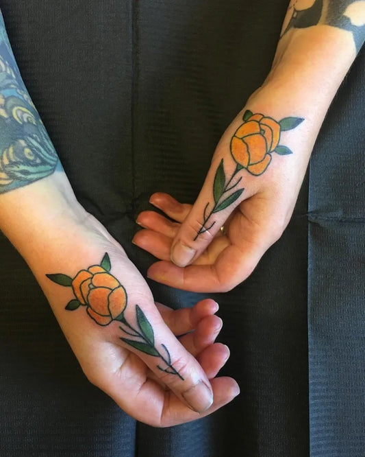 Small Neotraditional Orange Rose with Stem on Women Hands Tattoo by @sthlmclassictattoo