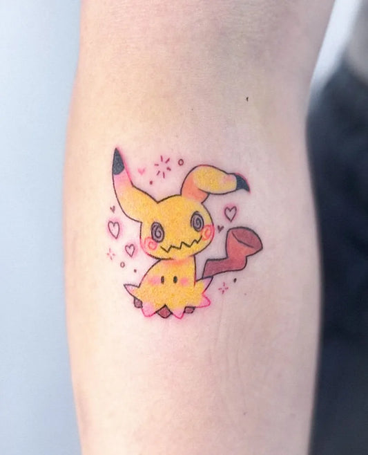 Small Neotraditional Pokemon Mimikyu Tattoo on Women Arm by @carrutsoup