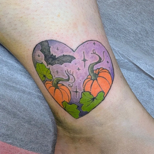 Small Neotraditional Purple Heart Bat Pumpkins Halloween Tattoo on Women Ankle by @stoneheart_inks