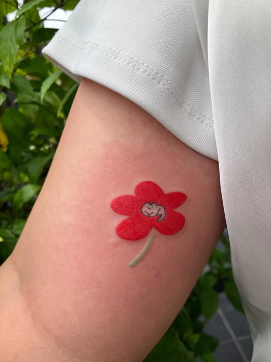 Small Neotraditional Red Poppy with Cat on Women Upper Arm Flower Tattoo by @white_house_studio_tattoo