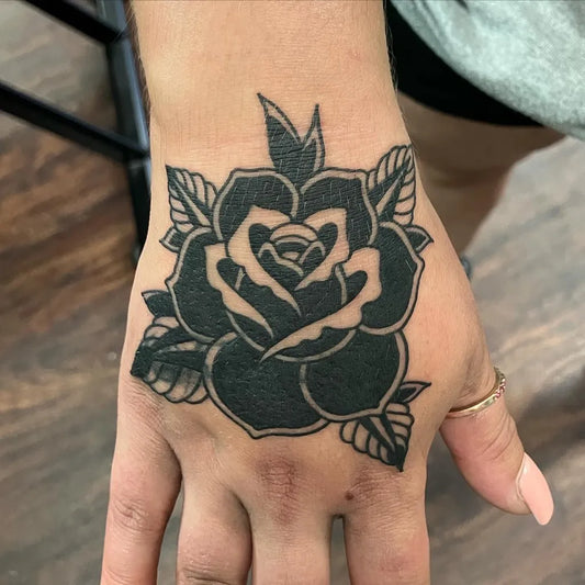 Small Neotraditional Rose on Women Hand Tattoo by @pacific_ave_tattoo