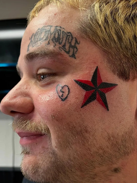 Small Neotraditional Skull Heart Star on Men Face Tattoo by @aurorakaisink