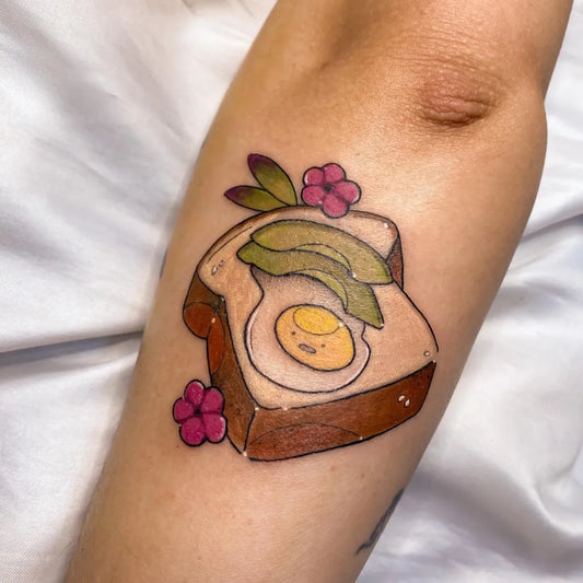 Small Neotraditional Toast Avocado Egg on Women Arm Tattoo by @mariaferrari.tattoo