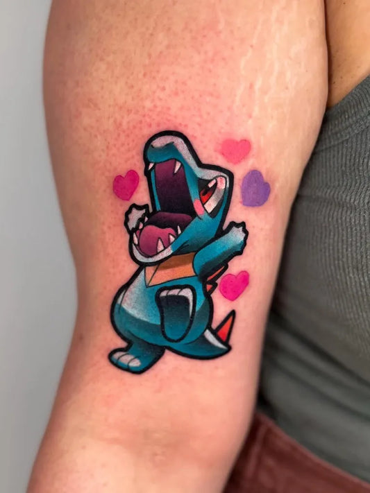 Small Neotraditional Totodile Pokemon Tattoo on Women Arm by @amylynn.colson
