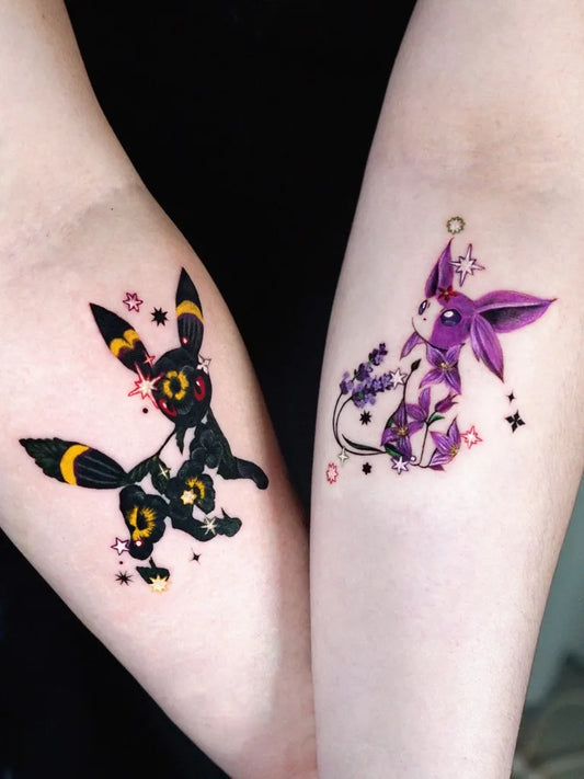 Small Neotraditional Umbreon and Espeon Tattoo on Women Arm by @tattooist_fluffy