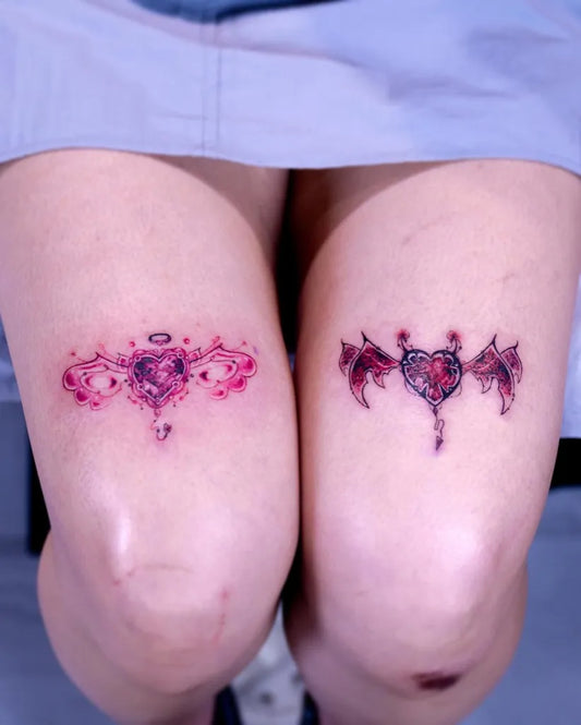 Small New School Angel Wings Heart Tattoo on Women Knees by @kitsch_tattooer