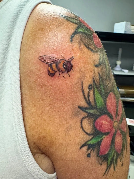 Small New School Bee and Flower on Men Shoulder Tattoo by @tatsbylaur
