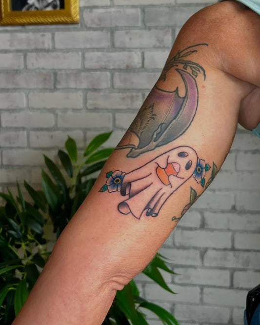 Small New School Ghost with Flowers Tattoo on Women Arm by @preston.tattoos