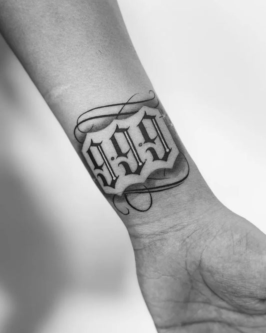 Small Old School 999 Banner Tattoo on Women Wrist by @tattoosbyvishal