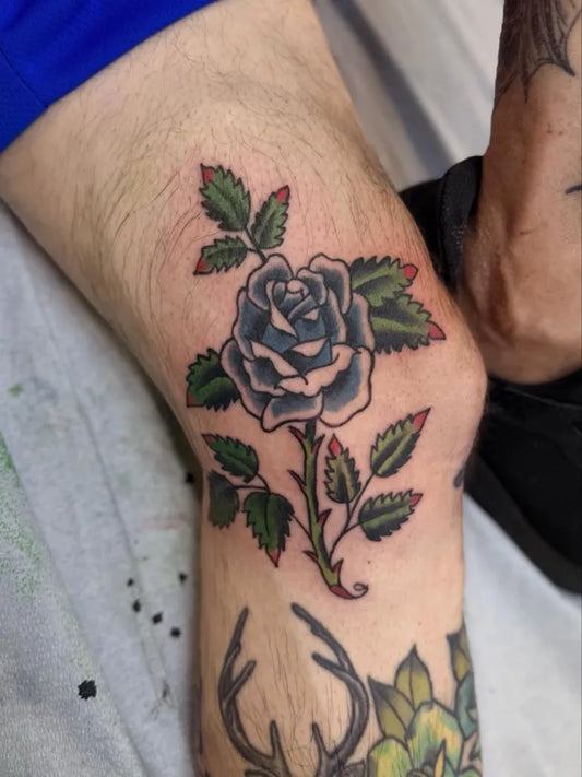 Small Old School Rose and Leaves on Men Knee Tattoo by @emeraldrosetattoo
