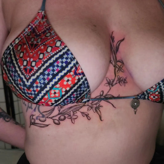 Small Olive Branch on Women Sternum Tattoo by @jay_davies_tattoos