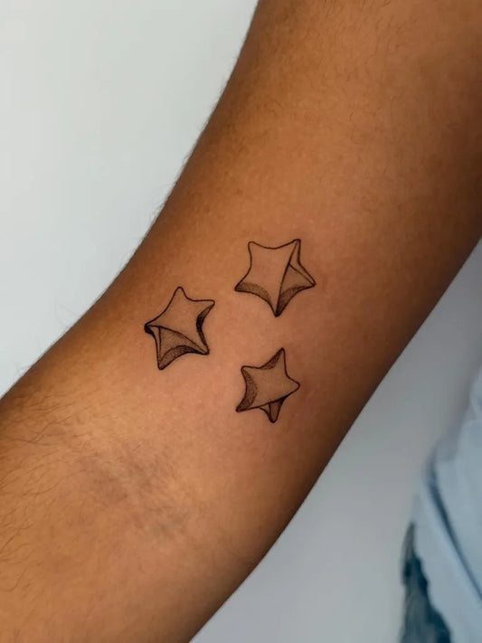 Small Origami Stars Tattoo on Women Arm by @it.yethicca