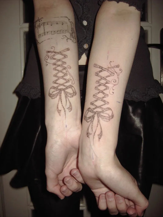 Small Ornamental Lace Bow Tattoo on Women Arm by @3mma.s_h3art